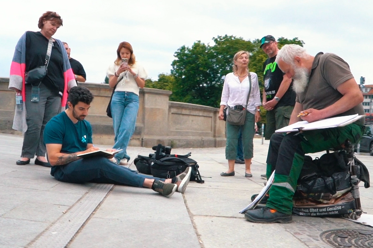 Me drawing alongside a street artist in Berlin for the Artwod travel series